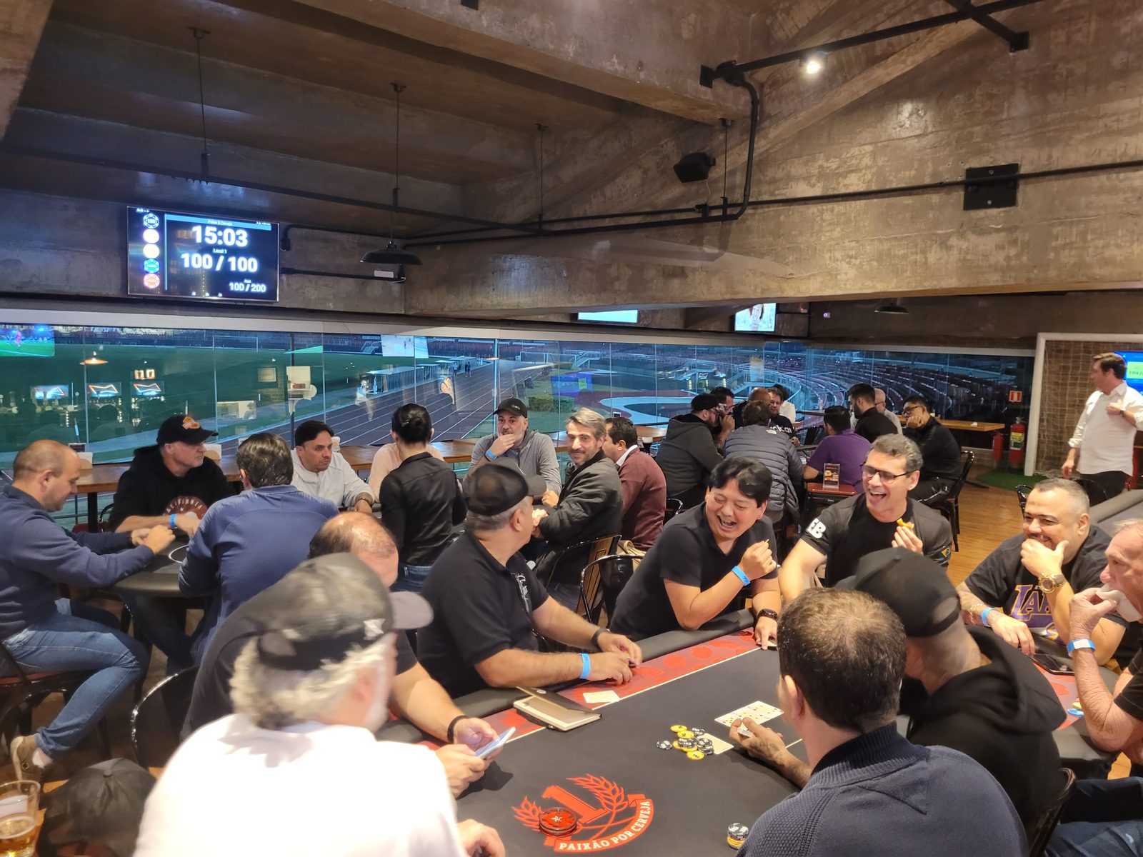 Jogadores em mesas de poker da HG durante um home game